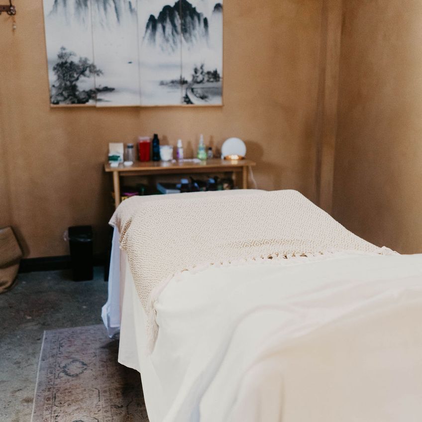 A treatment room with a massage table