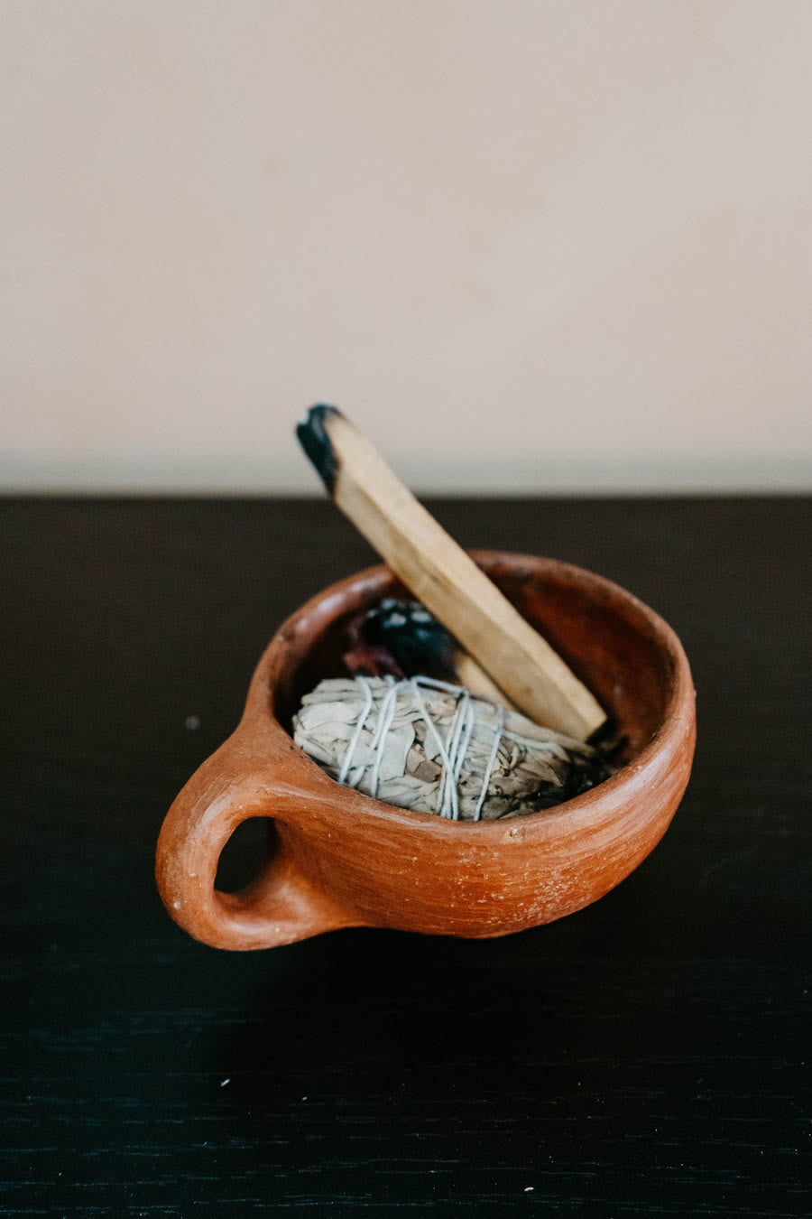 Palo santo in a clay bowl