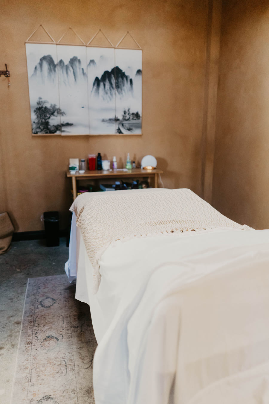 A treatment room with a landscape painting