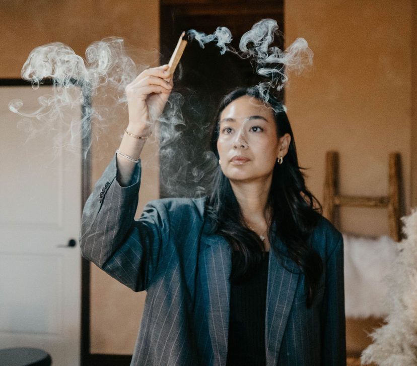 A practitioner holding a lit moxa stick